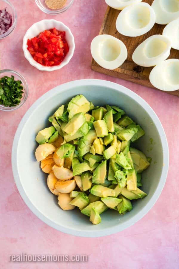 chopped avocado and egg yolks in a mixing bowl