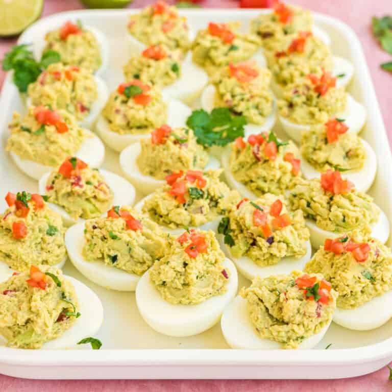 square image of guacamole deviled eggs on a serving platter
