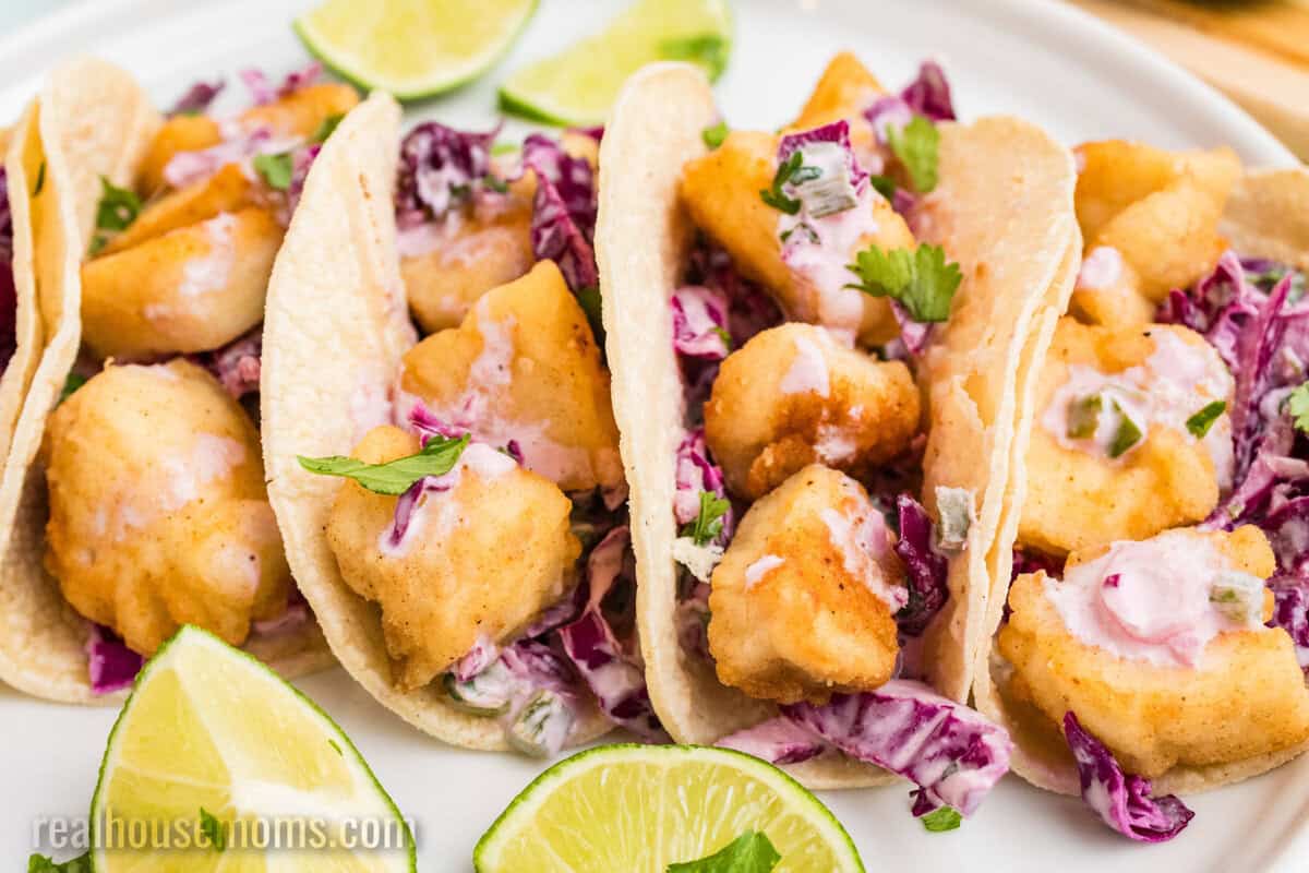 side view of halibut tacos arranged on a platter