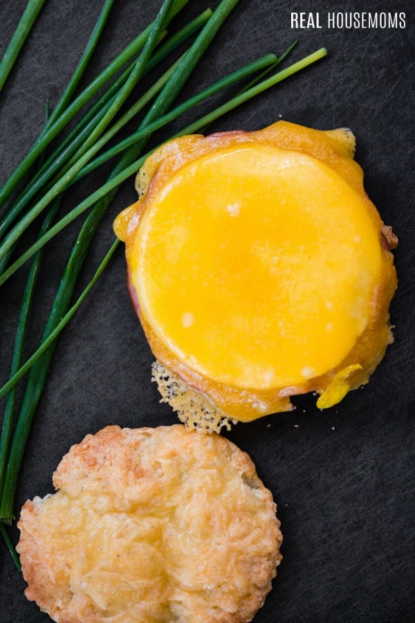 overhead view of ham egg and cheese breakfast slider with top biscuit sitting to the side