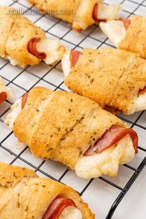 baked ham and cheese crescent rolls on a wire rack