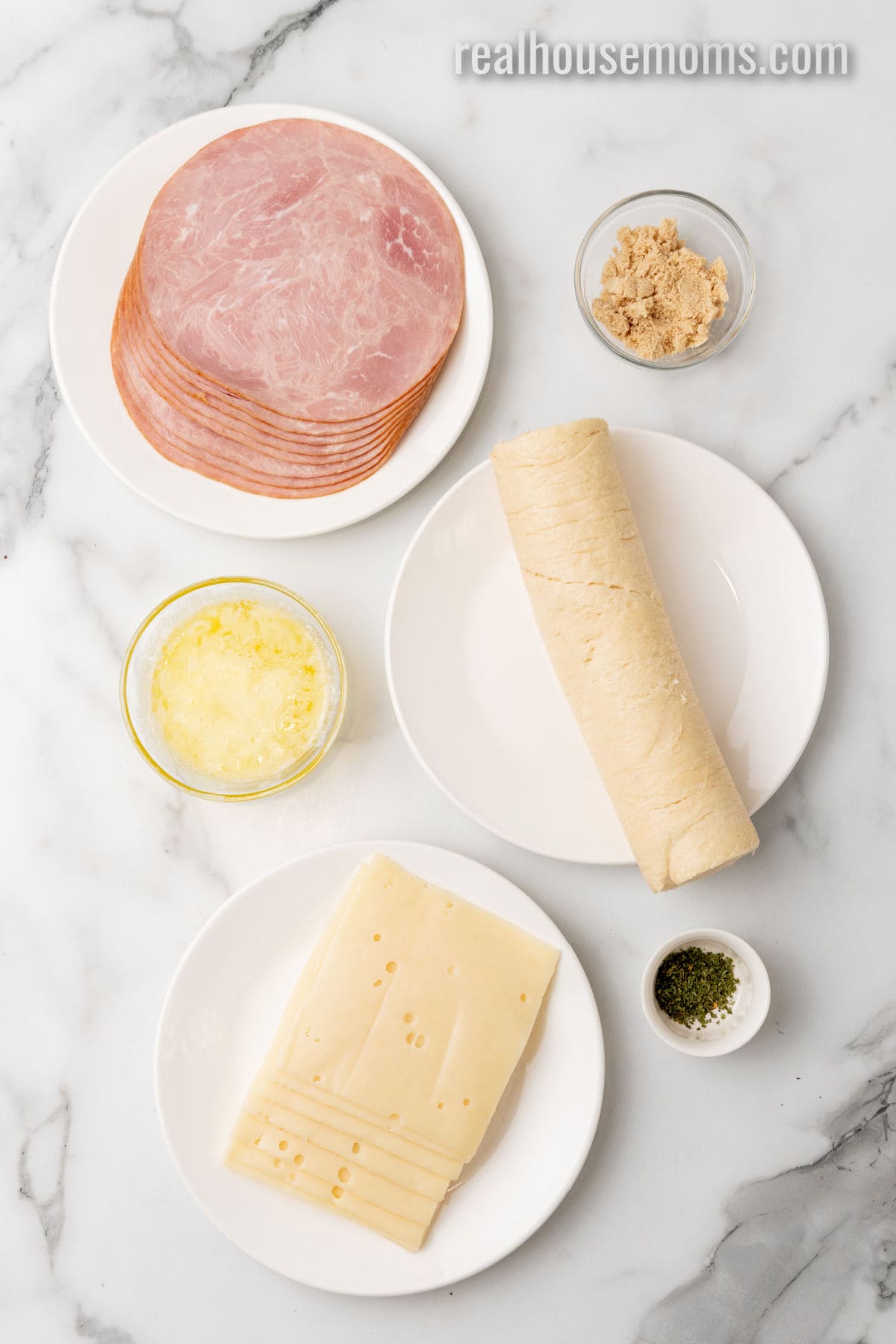 ingredients to make ham and cheese crescent rolls aid out on a counter