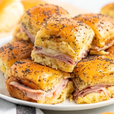 ham and cheese sliders piled up on a plate