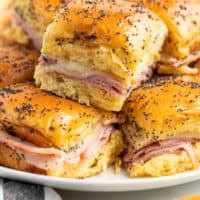 close up of ham and cheese slider with poppy seeds