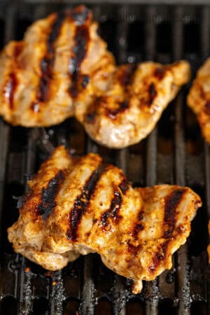 marinated harissa chicken thighs on a grill