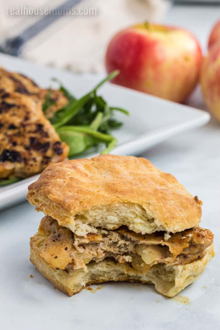 chicken apple sauce patty on a biscuit with a bite taken out