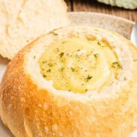 image of broccoli cheese soup in a homemade bread bowl with the title of the post on top of the image in pink and black lettering