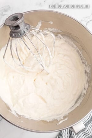homemade cool whip in a stand mixer bowl with the whisk attachment resting to one side