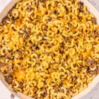 square image of homemade hamburger helper in a skillet with chopped parsley on top