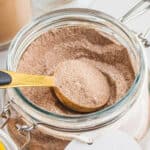 square image of a tablespoon of homemade vanilla chai mix resting in the jar