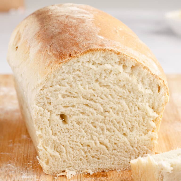 square image of homemade white bread loaf with the end cut off to show the crumb