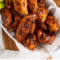 honey bbq chicken wings in a basket with recipe name at the bottom