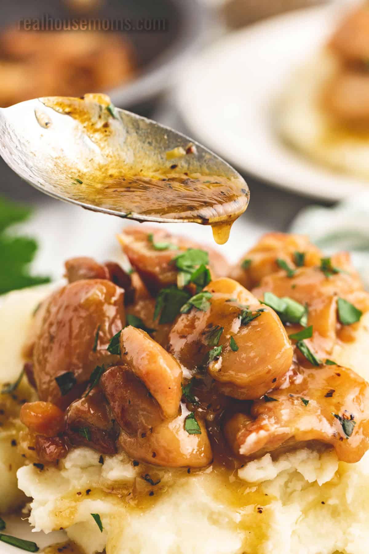 Honey Butter Chicken is better than take-out! If you want a quick and easy dinner then look no further than this juicy, sweet chicken dish! honey garlic butter sauce being drizzled over honey butter chicken