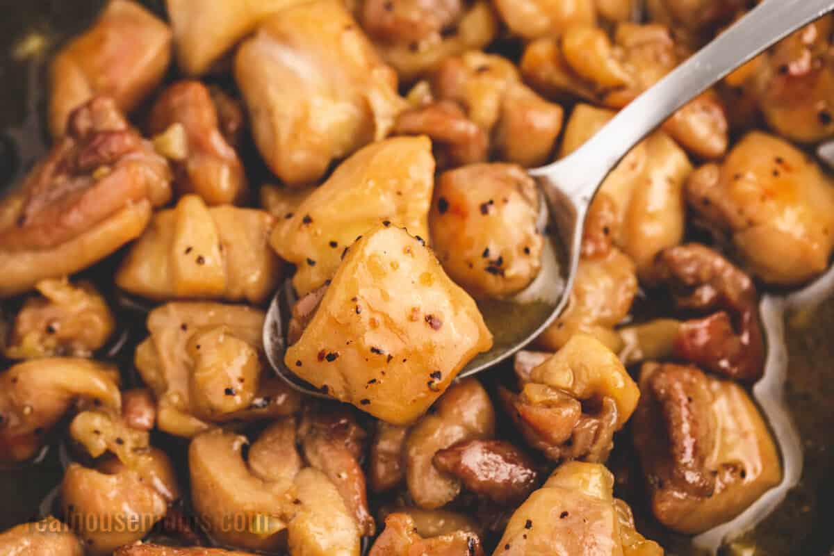 spoonful of honey butter chicken over the skillet