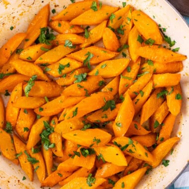 square image of honey garlic carrots topped with chopped parsley