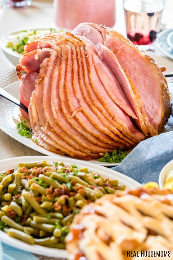 honey glazed crock pot ham on a table for a holiday meal