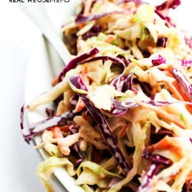 This HONEY SRIRACHA COLESLAW is made with 2 kinds of cabbage and a creamy honey dressing with a kick. Coleslaw has never tasted so good.