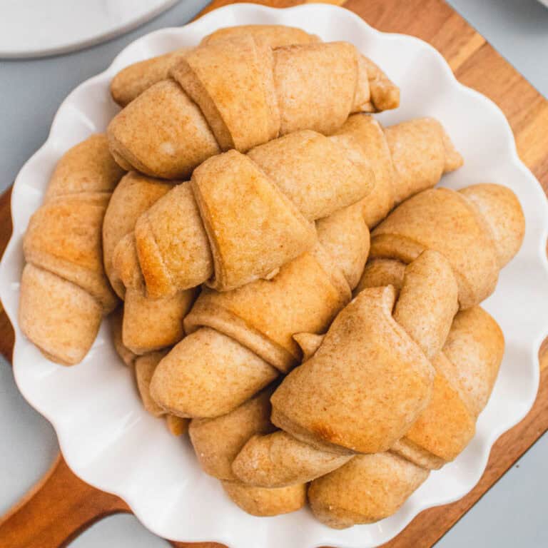 square image of a plate of honey wheat dinner rolls
