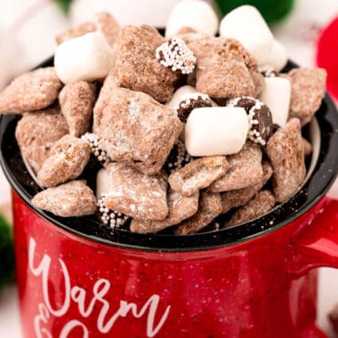 square close up of image of hot chocolate muddy buddies in a red metal mug