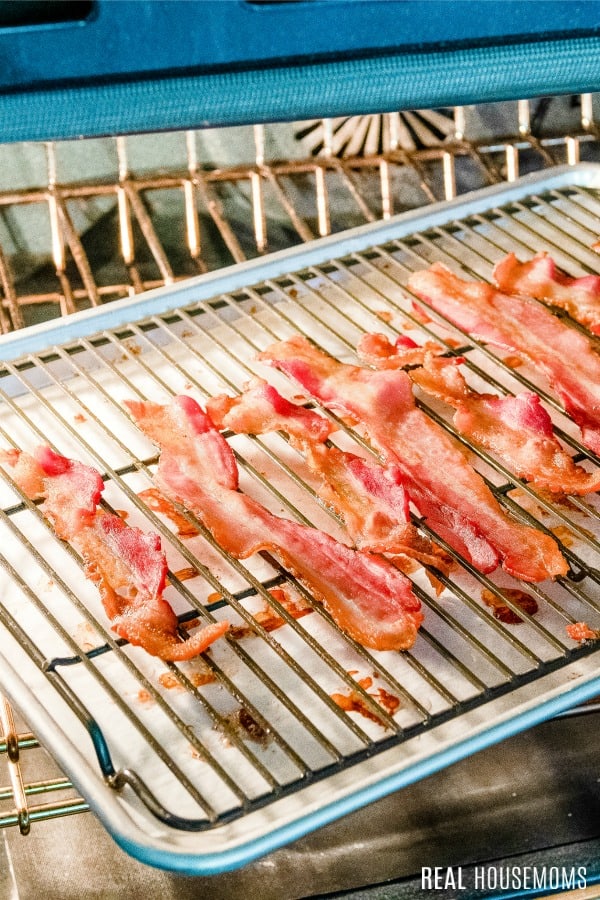 bacon on a baking sheet in an oven