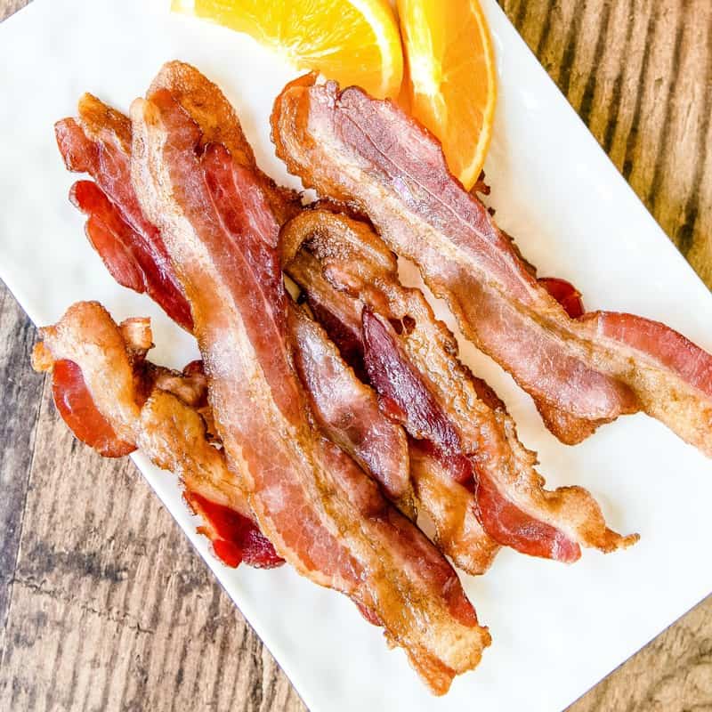 Learn the best, easy way to cook bacon in the oven perfect every time using the top hacks and tricks out there, including how long to cook oven bacon!