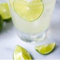 margarita in a rocks glass with ice and lime slices