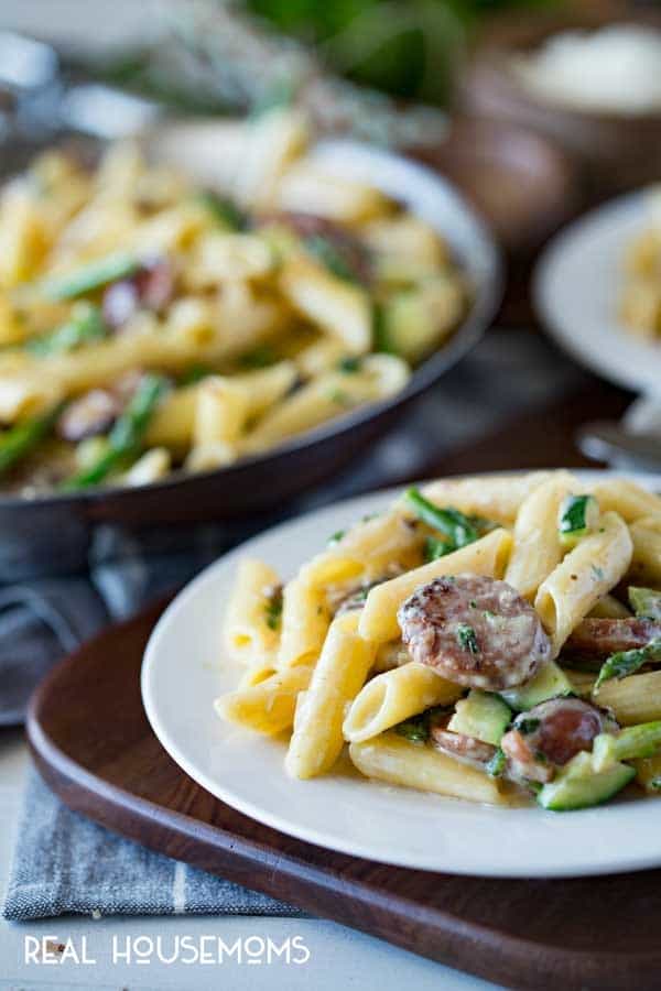 A creamy, flavorful cream sauce, a top penne, with summer sausages and your favorite green summer vegetables. This CREAMY SUMMER VEGGIE & SAUSAGE PENNE is sure to be a hit!