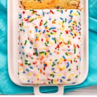 loaf of ice cream bread with slices cut from it on a platter with recipe name at the bottom