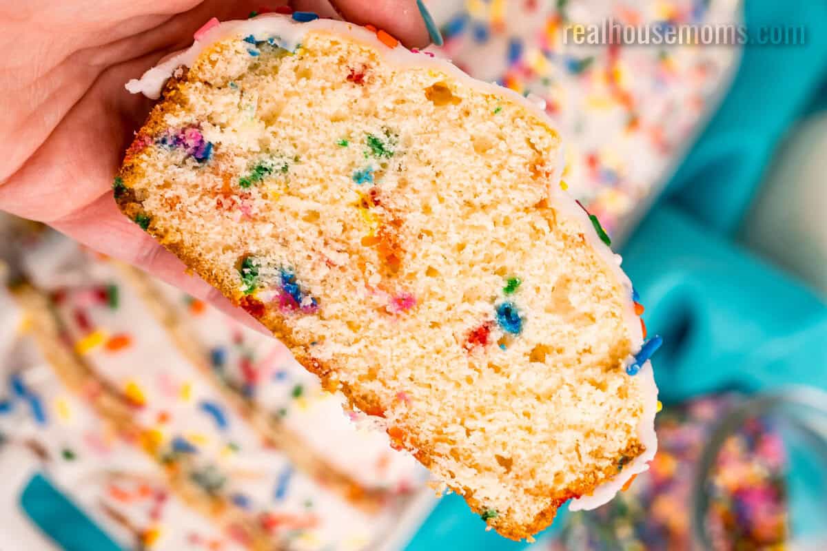 hand holding a slice of funfetti ice cream bread