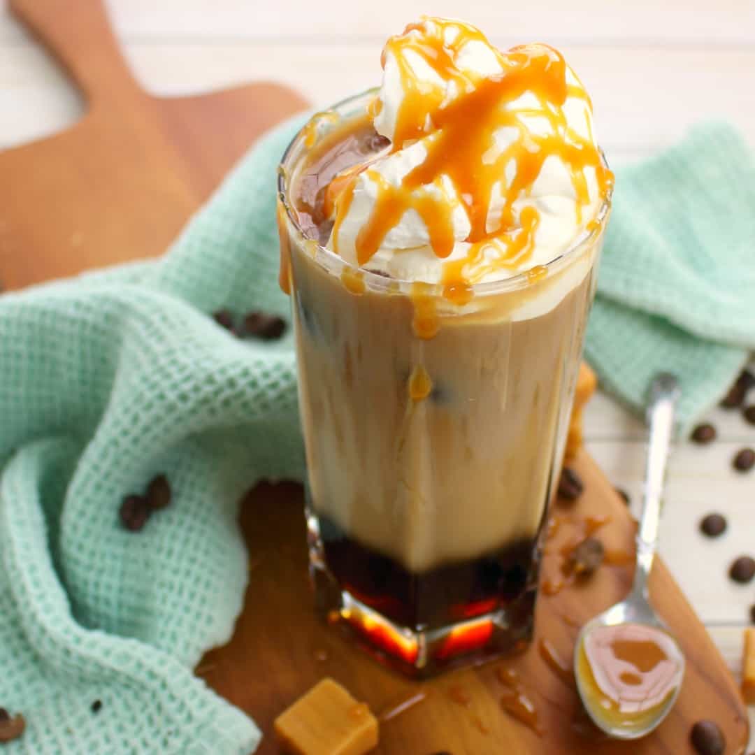 This Iced Caramel Macchiato recipe is the perfect iced coffee drink! Made with just a few simple ingredients, you'll quickly discover that you can make this coffee-house quality drink right at home!