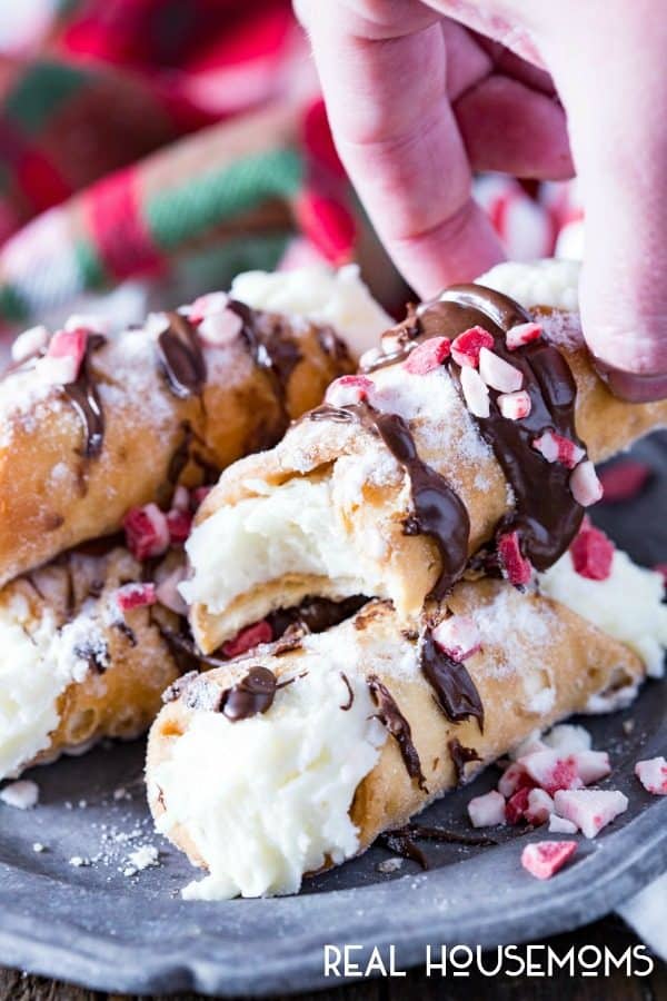 Peppermint whipped ricotta cream filling, a pie crust tube, and delicious chocolate drizzled on top make these easy Chocolate Drizzled Peppermint Cannoli the perfect holiday treat!