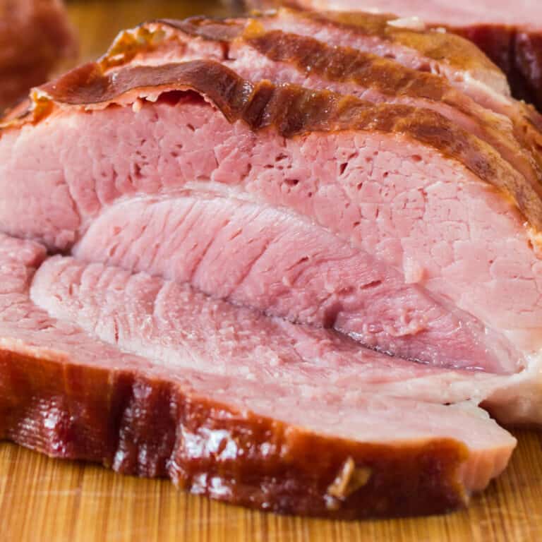 square image of instant pot ham slices on a cutting board