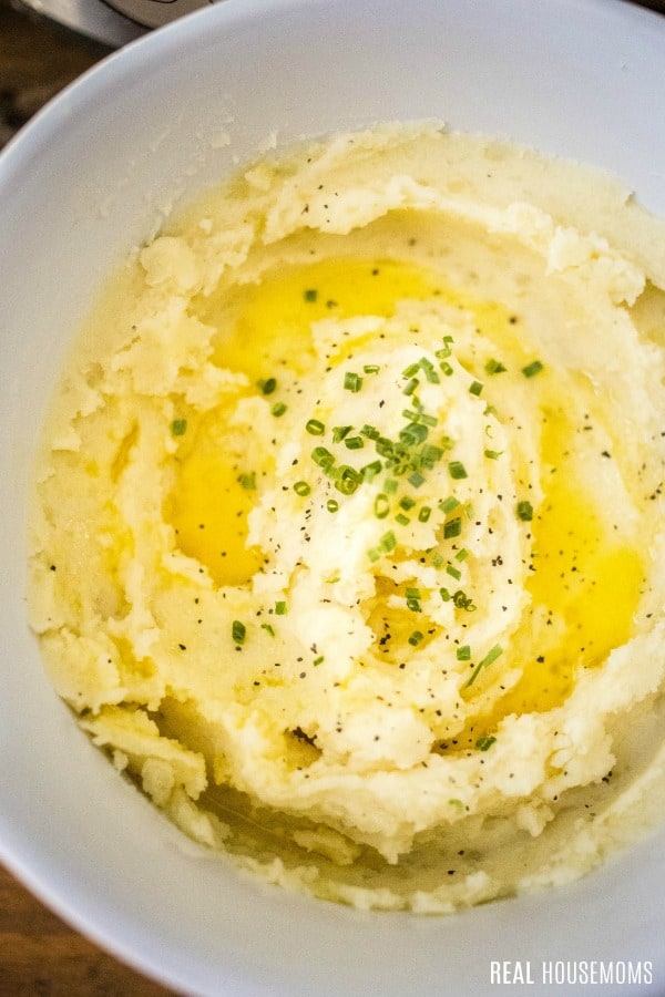 instant pot mashed potatoes ganished with chives, salt, and pepper