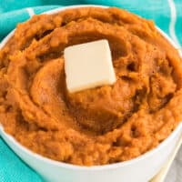 square image of instant pot mashed sweet potatoes in a bowl with a pat of butter on top