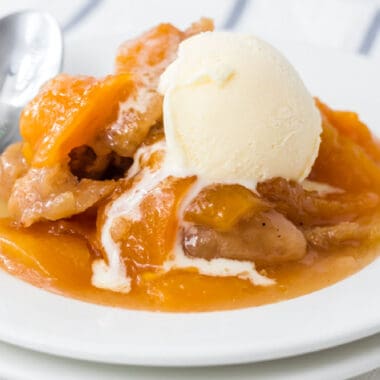 square image of instant pot peach cobbler won a plate with vanilla ice cream