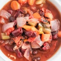 close up square image of a bowl of instant pot vegetarian soup