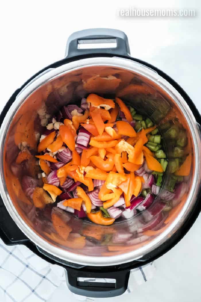 instant pot with onion, bell pepper, and celery