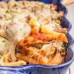 square image of a spoonful of Italian baked penne casserole over the baking dish
