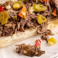 italian beef sandwich on a white plate with recipe name at the bottom