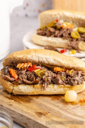 italian beef sandwiches with giardiniera on a cutting board