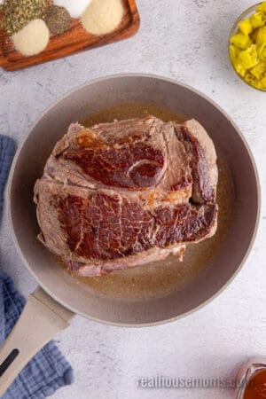 seared chuck roast in a skillet