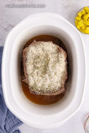 homemade seasoning blend for Italian beef spread over a seared chuck roast in a slow cooker