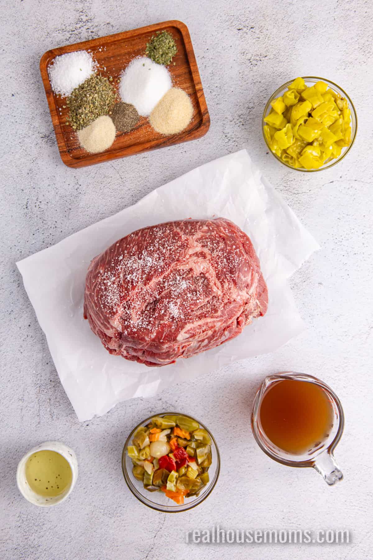 ingredients to make slow cooker ialian beef laid out on a counter