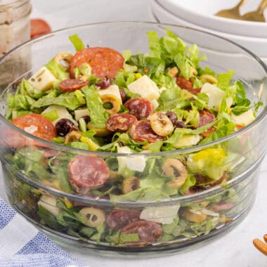 square image of italian chopped salad in a glass serving bowl