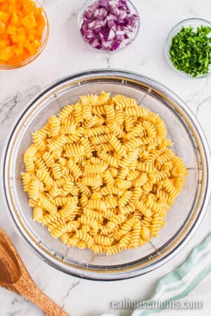 cooked and drained rotini pasta in a colander
