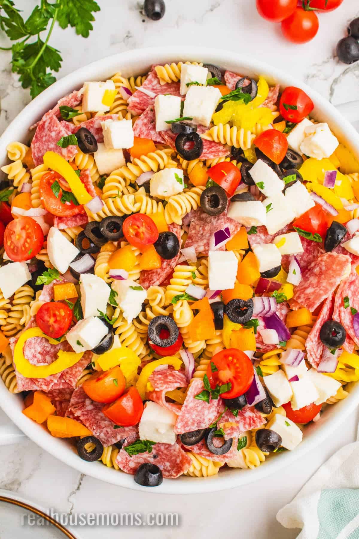 italian pasta salad in a large serving bowl after being tossed in dressing