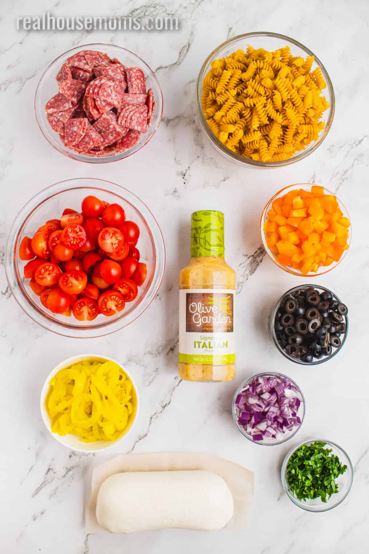 ingredients to make italian pasta salad laid out on a counter
