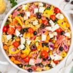 square image of italian pasta salad in a large white serving bowl