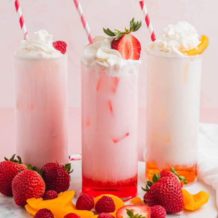 square image of three flavors of Italian soda on a tray with fresh fruit