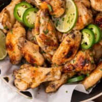 jalapeno lime chicken wings in a serving bowl with recipe name at the bottom